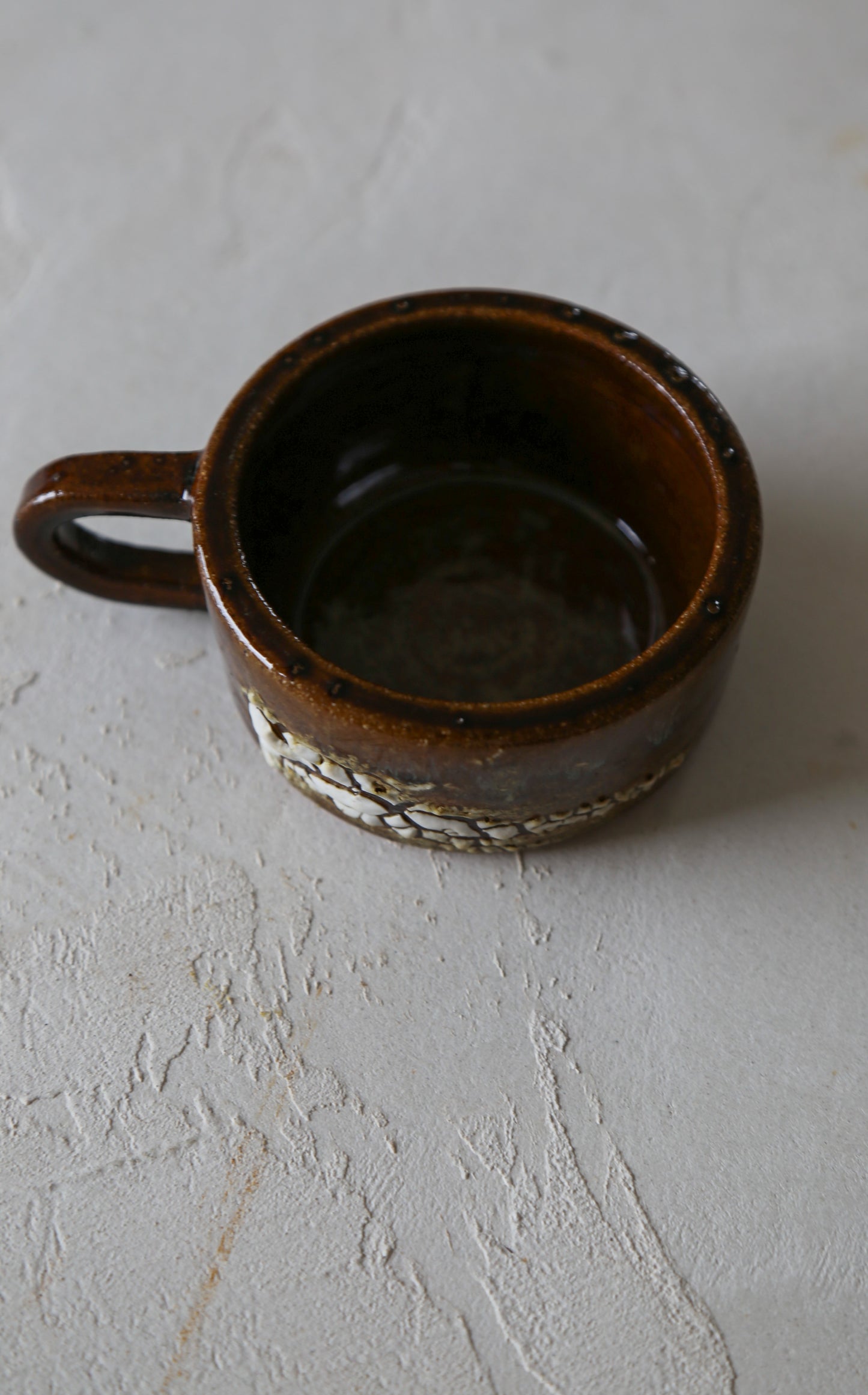 Cracked earth mug / dirty dishes
